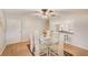Bright dining room with modern glass table and seating offers a pass-through to the kitchen at 12300 Vonn Rd # 7107, Largo, FL 33774