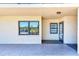 Welcoming condo entrance with neutral tones, featuring an entry door and a window reflecting the outside environment at 12300 Vonn Rd # 7107, Largo, FL 33774