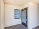 Welcoming entryway features neutral colors and a secure front door with clear unit number and storm door at 12300 Vonn Rd # 7107, Largo, FL 33774