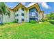 Well-maintained condo building featuring a lush green lawn and mature landscaping at 12300 Vonn Rd # 7107, Largo, FL 33774