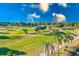 Expansive golf course featuring lush green grass, mature trees, and a clear blue sky at 12300 Vonn Rd # 7107, Largo, FL 33774