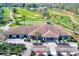 Overview of Largo Golf Course, featuring well-maintained greens, palm trees, a clubhouse, and golf carts at 12300 Vonn Rd # 7107, Largo, FL 33774