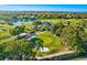 Picturesque aerial view of lush golf course with water features and mature trees at 12300 Vonn Rd # 7107, Largo, FL 33774