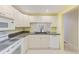 Clean kitchen with white cabinetry, granite countertops, and stainless appliances, offering great efficiency at 12300 Vonn Rd # 7107, Largo, FL 33774