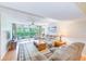 Comfortable living room boasts ample seating, neutral tones, and a seamless connection to outdoor living at 12300 Vonn Rd # 7107, Largo, FL 33774