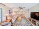 Open living room features comfortable seating, wood flooring, and views into the adjacent dining and kitchen areas at 12300 Vonn Rd # 7107, Largo, FL 33774