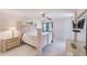 Cozy main bedroom featuring a ceiling fan, tile flooring, and soft natural light filtering through a window at 12300 Vonn Rd # 7107, Largo, FL 33774