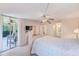 Spacious main bedroom with a sliding glass door to a patio, and en-suite bathroom at 12300 Vonn Rd # 7107, Largo, FL 33774