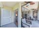 Enclosed patio featuring black trim windows allowing in natural light and ceiling fans for added comfort at 12300 Vonn Rd # 7107, Largo, FL 33774