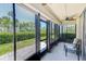Enclosed patio with black trim windows allowing for natural light and a peaceful view of the well-manicured landscaping at 12300 Vonn Rd # 7107, Largo, FL 33774