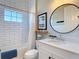 Stylish bathroom with subway tile, modern fixtures, and a framed mirror at 13706 Osprey Fern Ln, Riverview, FL 33569