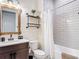 Bathroom featuring a wood-framed mirror, stylish vanity, and a shower with a white subway tile surround at 13706 Osprey Fern Ln, Riverview, FL 33569
