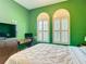 Comfortable bedroom featuring custom window shutters and a modern workstation at 13706 Osprey Fern Ln, Riverview, FL 33569