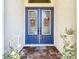 Welcoming double front doors with glass panels, decorative wreaths, and a 'Welcome Friends' mat at 13706 Osprey Fern Ln, Riverview, FL 33569