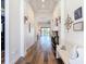 Bright hallway with wood floors, elegant decor, and an arched entryway leading to the living area at 13706 Osprey Fern Ln, Riverview, FL 33569
