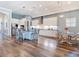 Spacious kitchen with white cabinetry, stainless steel appliances, a large island, and wood floors at 13706 Osprey Fern Ln, Riverview, FL 33569