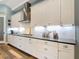 Updated kitchen with white cabinets, stainless steel appliances, and modern fixtures at 13706 Osprey Fern Ln, Riverview, FL 33569