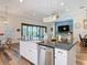 Open kitchen with a large island, stainless steel appliances, and seamless access to outdoor living at 13706 Osprey Fern Ln, Riverview, FL 33569