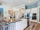 Spacious kitchen featuring stainless appliances, a central island, and open layout at 13706 Osprey Fern Ln, Riverview, FL 33569