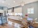 Charming kitchen featuring a breakfast nook, modern lighting, and updated appliances at 13706 Osprey Fern Ln, Riverview, FL 33569