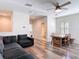Open concept living area with hardwood floors, cozy seating and view into an adjacent bathroom at 13706 Osprey Fern Ln, Riverview, FL 33569