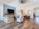 Cozy living room with a brick fireplace, comfortable seating, and an open layout to the dining area at 13706 Osprey Fern Ln, Riverview, FL 33569