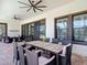Covered patio with an outdoor dining area, ceiling fans, and seamless access to the backyard at 13706 Osprey Fern Ln, Riverview, FL 33569