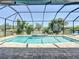 Backyard featuring a screened-in pool and spa, perfect for relaxation and entertainment at 13706 Osprey Fern Ln, Riverview, FL 33569