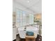 Bright bathroom featuring a soaking tub under a window with plantation shutters and mirrored walls at 13872 Siena Loop, Lakewood Ranch, FL 34202