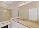 Bright bathroom featuring tile surround in shower, white vanity, and a large mirror at 13872 Siena Loop, Lakewood Ranch, FL 34202