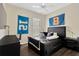 Cozy bedroom featuring sporty decor, a ceiling fan, and a comfortable bed with modern furniture at 13872 Siena Loop, Lakewood Ranch, FL 34202
