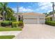 Charming single-story home featuring a three-car garage, well-manicured landscaping, and tile roof at 13872 Siena Loop, Lakewood Ranch, FL 34202