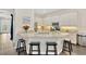 Kitchen island with granite countertops and breakfast bar seating, open to dining and living areas at 13872 Siena Loop, Lakewood Ranch, FL 34202