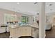 Spacious kitchen with stainless steel appliances, island with seating, and open floor plan to living spaces at 13872 Siena Loop, Lakewood Ranch, FL 34202