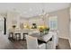 Open-concept kitchen and dining area with stylish chandelier lighting and lots of natural light at 13872 Siena Loop, Lakewood Ranch, FL 34202