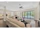Bright living space leads to outdoor pool area through sliding glass doors, promoting indoor-outdoor living at 13872 Siena Loop, Lakewood Ranch, FL 34202