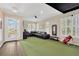Recreation room featuring a golf simulator and impact screen with an oversized leather couch and media center at 13872 Siena Loop, Lakewood Ranch, FL 34202