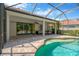 Screened-in lanai featuring a pool, covered seating area with outdoor furniture, and ceiling fan at 13872 Siena Loop, Lakewood Ranch, FL 34202