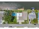 Aerial view shows the home's layout, pool, dock, waterfront location, and proximity to neighboring houses at 1449 45Th Ne Ave, St Petersburg, FL 33703