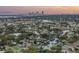 Sunset aerial view of a beautiful waterfront community with scenic waterways and city skyline in the distance at 1449 45Th Ne Ave, St Petersburg, FL 33703
