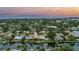 Waterfront community aerial showcases tree-lined streets and a beautiful waterfront canal extending to the ocean at 1449 45Th Ne Ave, St Petersburg, FL 33703