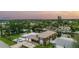 Aerial view of the property showcasing the home, lush landscaping, waterfront canal access, and neighborhood at 1449 45Th Ne Ave, St Petersburg, FL 33703