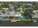 Aerial view of the property showcasing a private pool, a wooden dock, and access to a waterfront canal at 1449 45Th Ne Ave, St Petersburg, FL 33703