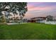Beautifully landscaped backyard featuring a large pool, covered patio, and lush green lawn at 1449 45Th Ne Ave, St Petersburg, FL 33703