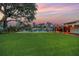 Expansive backyard featuring well-maintained lawn, a sparkling pool, and a covered patio ideal for outdoor living at 1449 45Th Ne Ave, St Petersburg, FL 33703