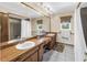 Bathroom featuring dual sinks, a large mirror, and a shower-tub combination at 1449 45Th Ne Ave, St Petersburg, FL 33703