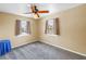 Bright bedroom with neutral walls, ceiling fan, carpet flooring, and natural light from two windows at 1449 45Th Ne Ave, St Petersburg, FL 33703
