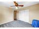Inviting bedroom with neutral walls, ceiling fan, carpet flooring, and a closet at 1449 45Th Ne Ave, St Petersburg, FL 33703