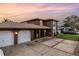Exterior of home with arched entryway, a spacious three-car garage, and concrete driveway at 1449 45Th Ne Ave, St Petersburg, FL 33703