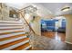 Grand foyer showcasing a wooden staircase, chandelier, and archway into the living room at 1449 45Th Ne Ave, St Petersburg, FL 33703